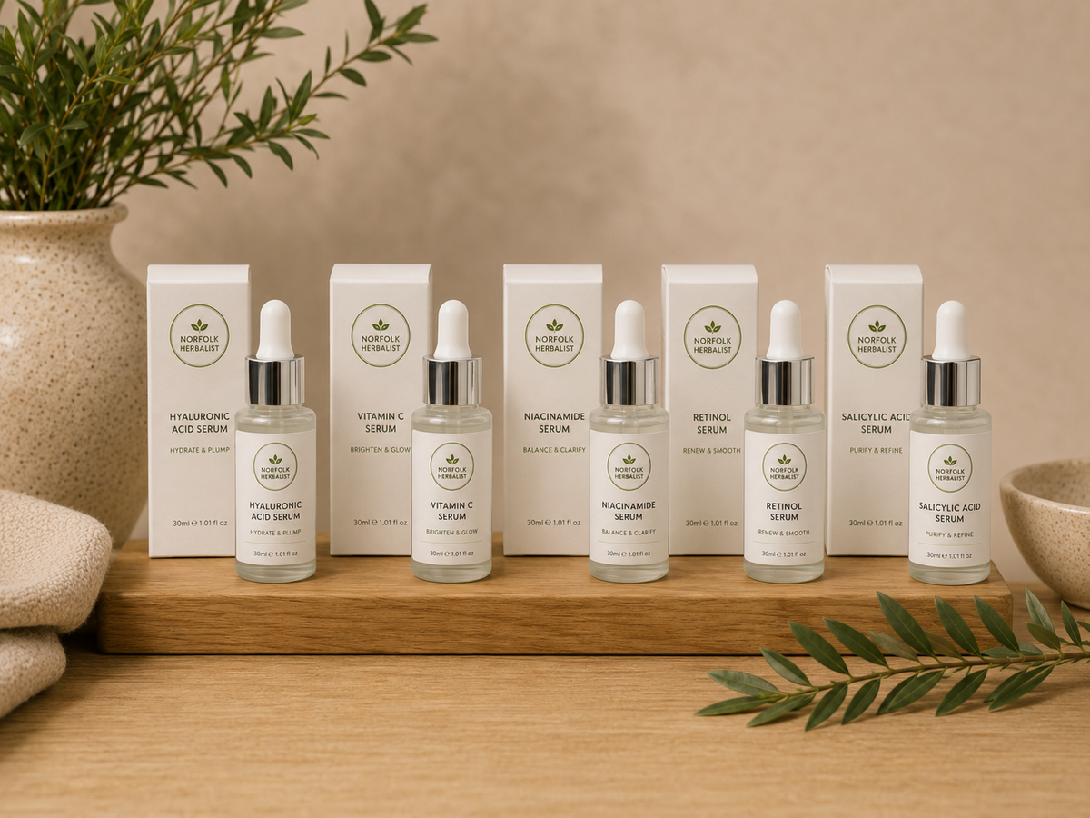 The Norfolk Herbalist facial serums with product boxes and bottles